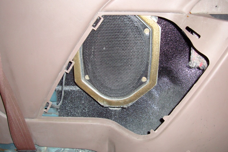Factory oval speaker mounted in a vehicle interior panel cutout