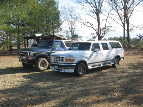 1978 Ford Bronco - Photo of a white Ford crew-cab and a vintage Bronco parked together, not a technical document.
