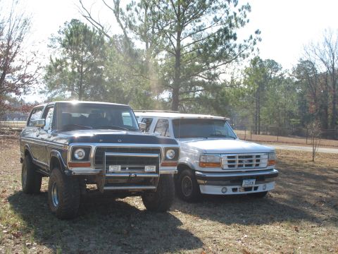1978 Ford Bronco - Photo of a dark Ford Bronco and a white Ford parked outdoors, not a technical document.