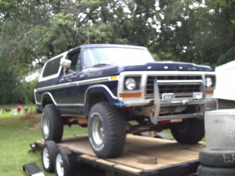 1978 Ford Bronco - A lifted 1978 Ford Bronco is viewed from a three-quarter front angle while on a trailer.