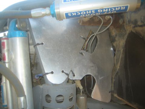 1990 Ford Bronco - Photograph of an off-road racing shock and aluminum panel in a vehicle, not a technical document.