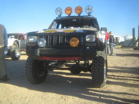 1990 Ford Bronco - Photo of a lifted Jeep Cherokee at an off-road event, not a technical document.