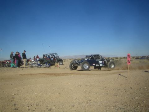 1990 Ford Bronco - Photo of an off-road race buggy on a desert course, not a technical document.