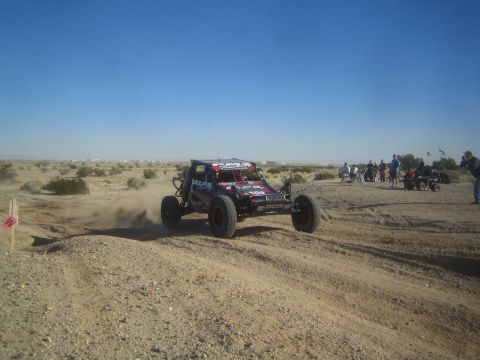 1990 Ford Bronco - Photo of an off-road race buggy on a desert course, not a technical document.