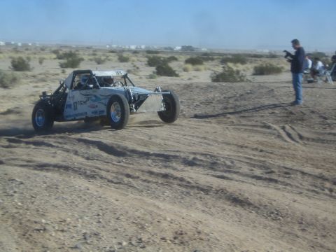 1990 Ford Bronco - Photo of an off-road race buggy on a desert course, not a technical document.