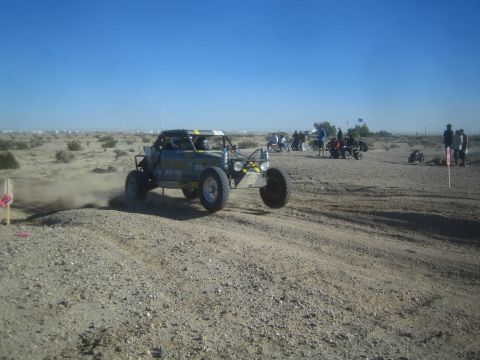 1990 Ford Bronco - Photo of an off-road race buggy in the desert, not a technical document.