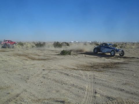 1990 Ford Bronco - Photograph of a blue off-road race buggy in the desert, not a technical document.