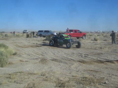 1990 Ford Bronco - Photograph of an off-road race buggy in the desert, not a technical document.