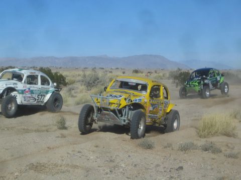 1990 Ford Bronco - Photograph of off-road race buggies in the desert, not a technical document.