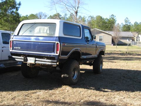 1978 Ford Bronco - Photograph of a lifted blue Ford Bronco from the rear quarter, not a technical document.