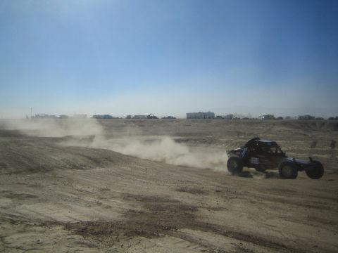 1990 Ford Bronco - Action photo of an off-road buggy at speed across a desert flat, not a technical document.