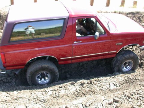 1996 Ford Bronco - This 1996 Ford Bronco is stuck in the dirt, showing its side profile.
