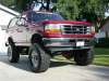1996 Ford Bronco - Very small thumbnail of a red 1992-96 Ford Bronco with a tall suspension lift and oversized tires, viewed from the front three-quarter angl…