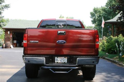 2006 Ford F-150 - Rear view of a red 2006 Ford F-150 pickup truck parked in a driveway.