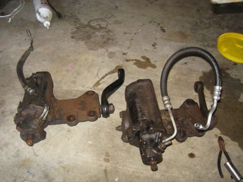 1978 Ford Bronco - Two power steering components are shown on a concrete surface, possibly for repair or replacement.