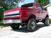 1996 Ford Bronco - Very small thumbnail of a red lifted Ford Bronco viewed from the rear three-quarter angle, showing the striped tailgate, chrome rear bumper…