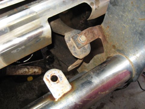 1978 Ford Bronco - Detail of a corroded bracket and exhaust pipe, likely from an older vehicle.