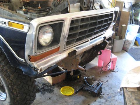 1978 Ford Bronco - The front end of a 1978 Ford Bronco is shown with its grille and bumper removed for repair.