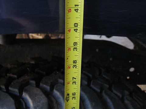 1978 Ford Bronco - Measuring tire height with a tape measure, showing approximately 36-41 inches.