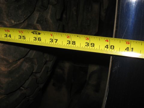 1978 Ford Bronco - A yellow measuring tape is placed against a large tire, indicating a measurement of approximately 40 inches.
