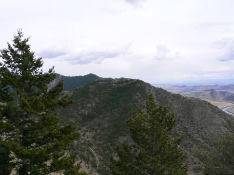 2006 Ford E350 - A vast mountain landscape unfolds with a river snaking through the valley below a cloudy sky.