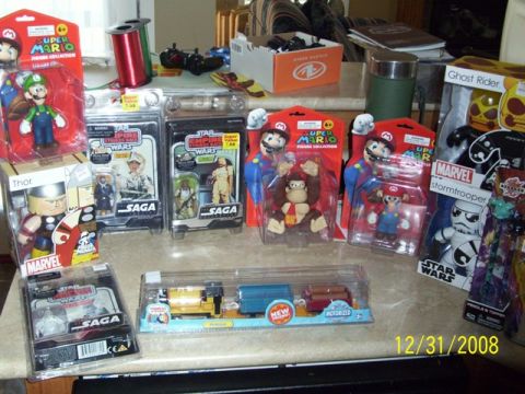 1991 Ford Bronco - Various collectible toys including action figures and a toy train set are displayed on a table.