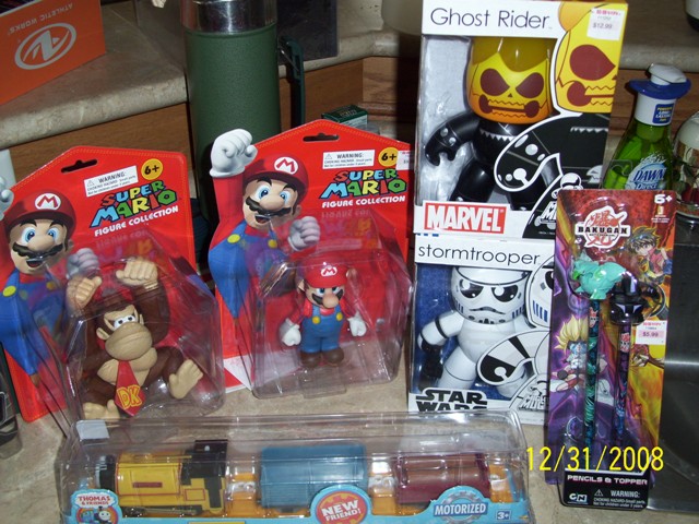 Mario, Donkey Kong, Stormtrooper, and Bakugan toys with a Thomas the Train set