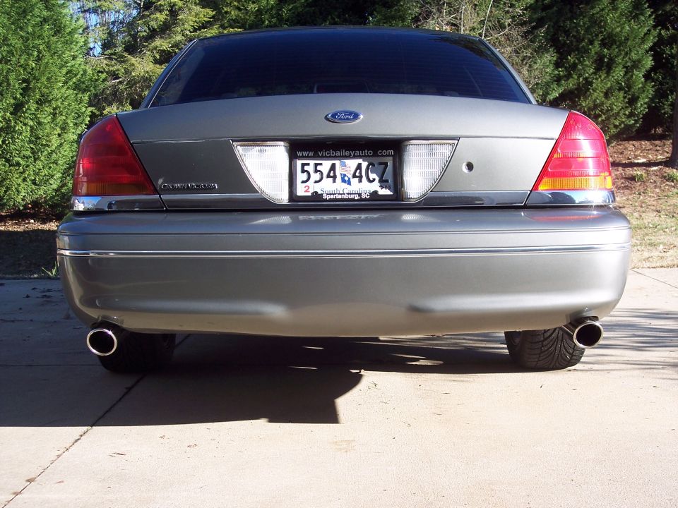 Rear view of a gray Ford Crown Victoria with a license plate reading 554 4CZ