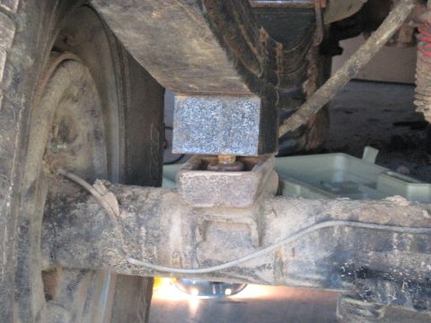 1978 Ford Bronco - A lift block is installed between the leaf spring and the axle of a vehicle for added height.