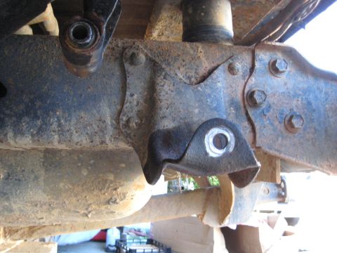 1978 Ford Bronco - Detail of a vehicle's suspension system, showing a rusty bracket and mounting hardware.