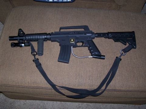 1986 Ford Bronco - This is a black paintball gun with a sling and flashlight attachment.