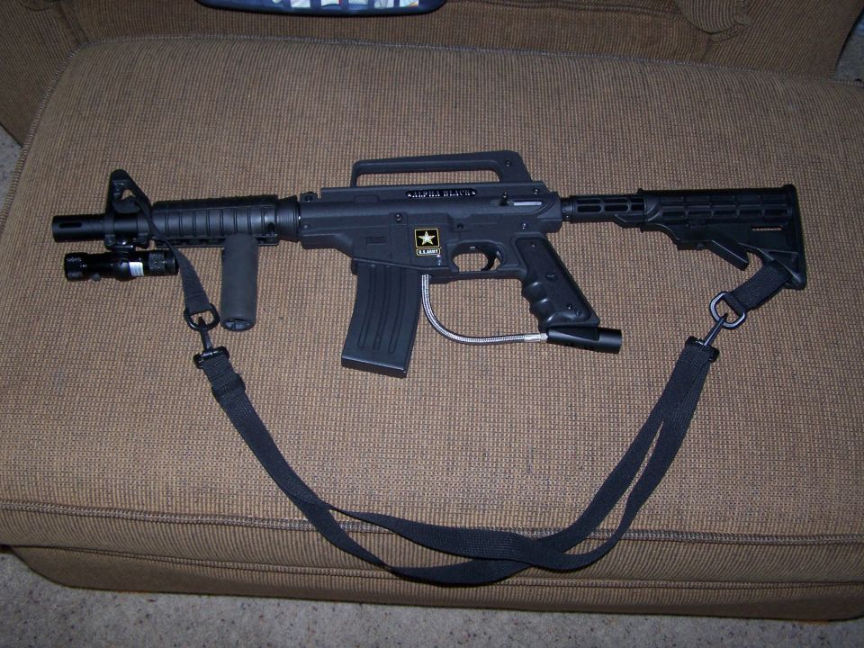 Black paintball gun with a sling, mounted flashlight, and an "ARMY" star logo