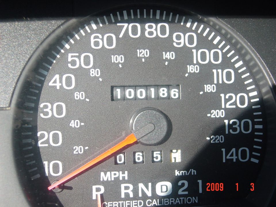 Speedometer showing 100 mph and odometer reading 100186. Also shows gear selector P R N D 2 1