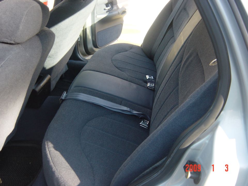 Gray fabric rear seats and seatbelts in a 2000 Ford Crown Victoria