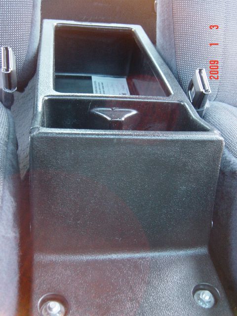 2000 Ford Crown Victoria - A close-up view of the center console and a seatbelt buckle, with a date stamp of 2009.