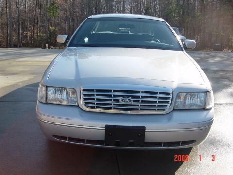 2000 Ford Crown Victoria - Front view of a silver 2000 Ford Crown Victoria, showing its distinctive grille and headlights.