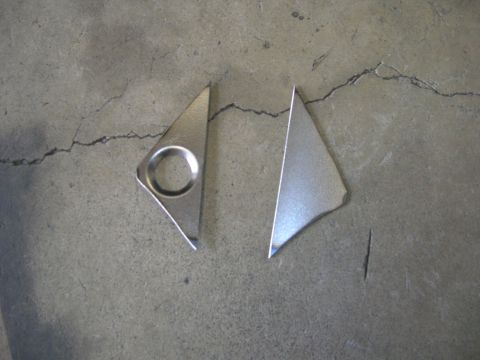 1996 Ford Bronco - Two metal trim pieces are shown on a cracked concrete surface.