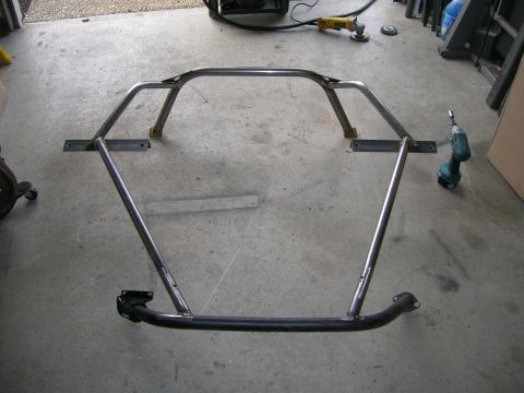 1996 Ford Bronco - A custom-fabricated roll cage is shown on a concrete floor, likely in a workshop or garage setting.