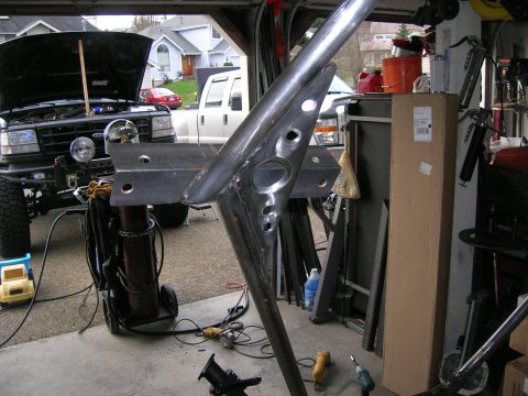 1996 Ford Bronco - A custom metal fabrication project is underway in a garage, with a Ford truck visible in the background.