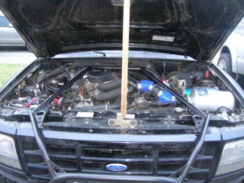 1996 Ford Bronco - Engine bay view shows aftermarket turbocharger and nitrous oxide system installed.