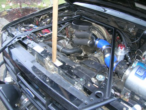 1996 Ford Bronco - The engine bay shows aftermarket modifications, including blue intercooler piping and a blow-off valve.