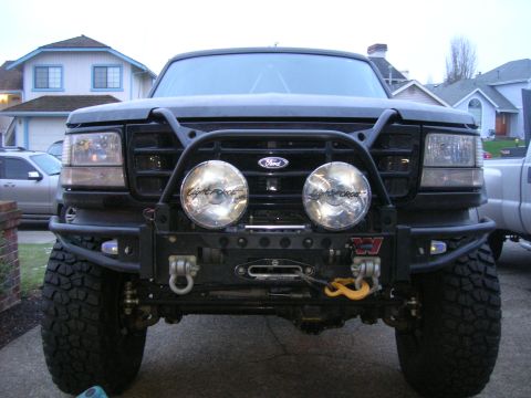 1996 Ford Bronco - Front view of a 1996 Ford Bronco equipped with an aftermarket bumper, winch, and auxiliary lights.