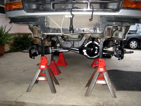 1996 Ford Bronco - The front suspension of a 1996 Ford Bronco is elevated on jack stands for maintenance.