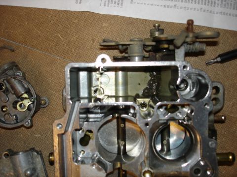1987 Ford Crown Victoria LTD - Disassembled carburetor showing internal mechanisms and parts, likely for rebuild or tuning.