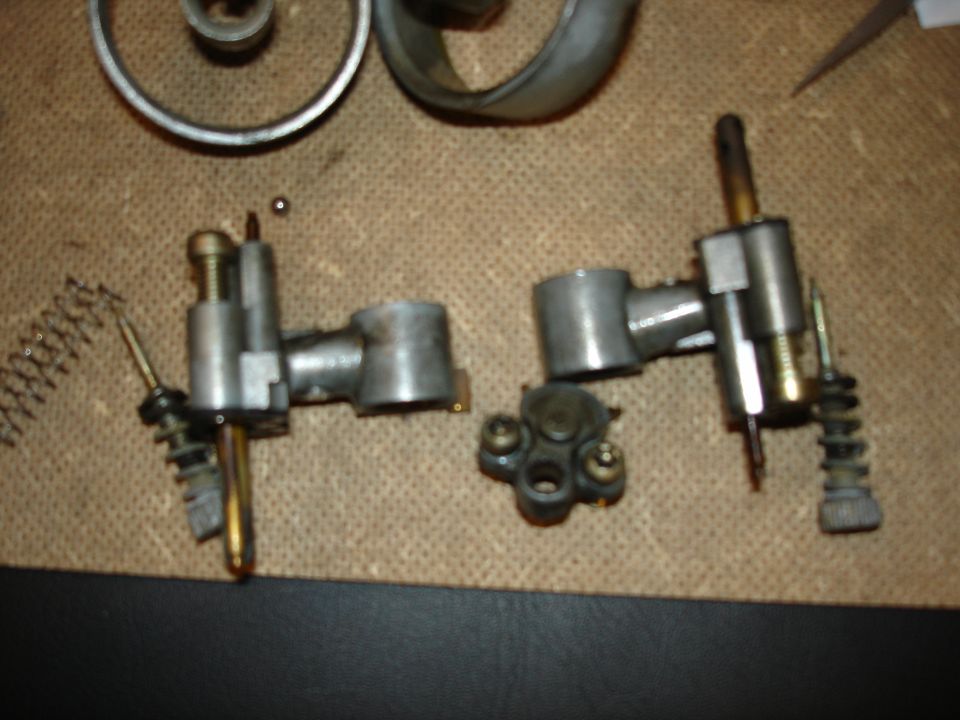 Carburetor components and springs on a textured surface