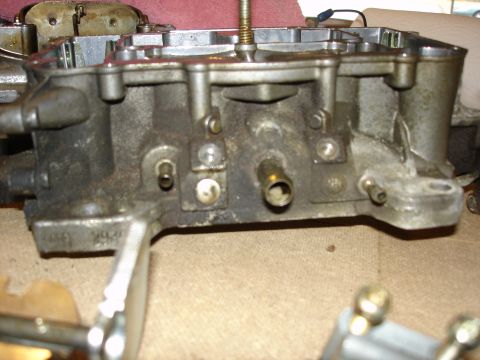 1987 Ford Crown Victoria LTD - Close-up view of a carburetor, likely undergoing rebuild or tuning.