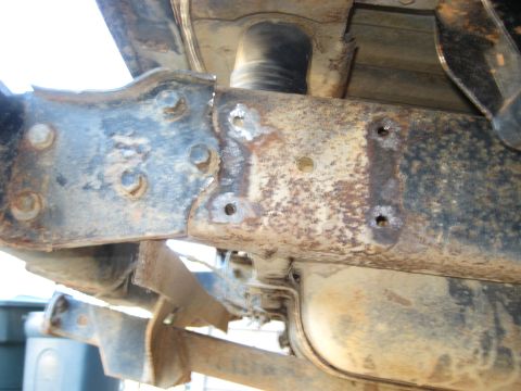 1978 Ford Bronco - The heavily rusted frame shows signs of modification and wear.