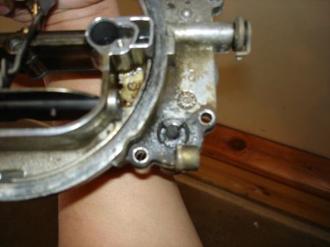 1987 Ford Crown Victoria LTD - A close-up view of a carburetor part, likely undergoing rebuild or tune-up.