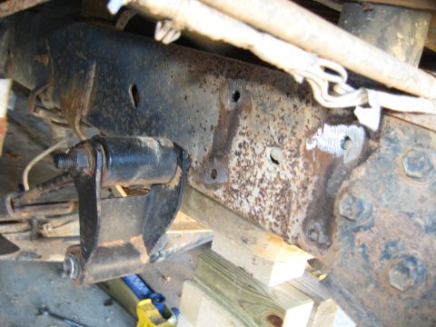 1978 Ford Bronco - Close-up view of a heavily rusted vehicle frame and suspension components, indicating age and wear.