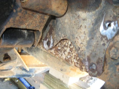 1978 Ford Bronco - Detail of heavily rusted vehicle frame components, showing signs of repair and wear.